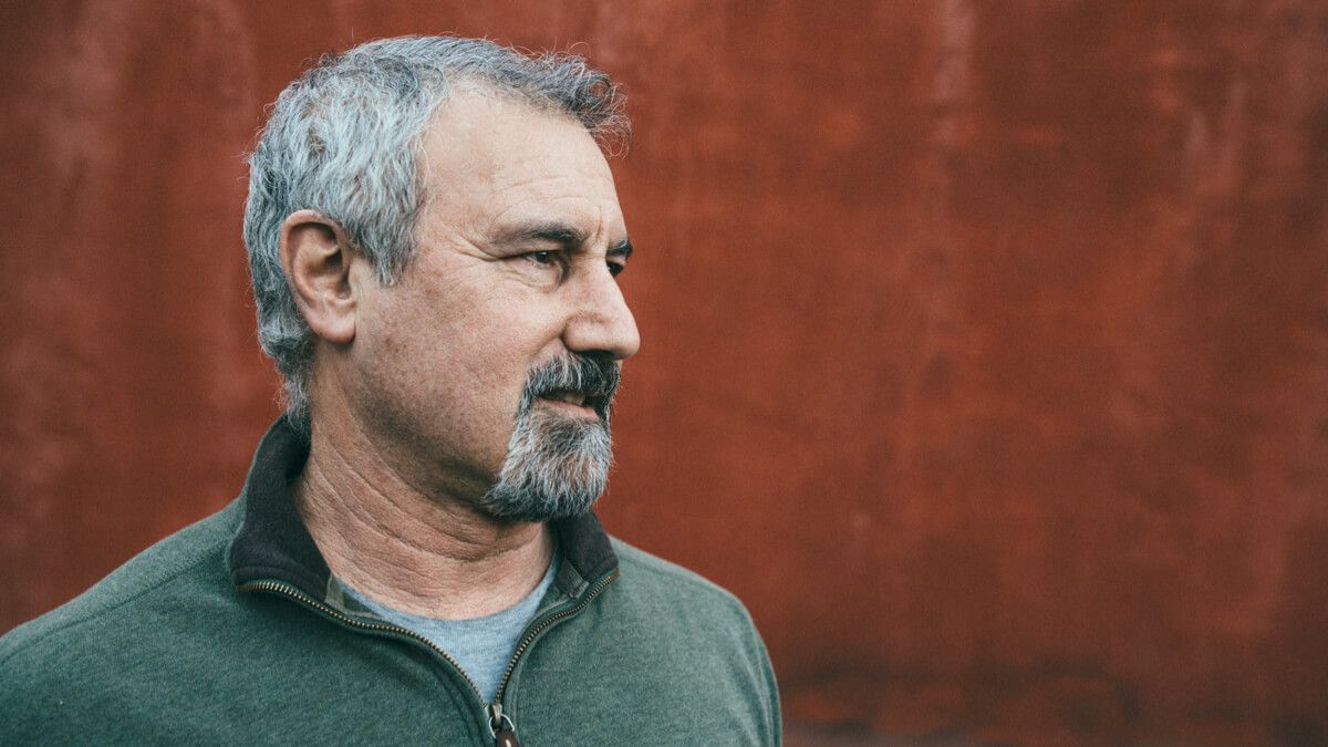 Close up of middle-aged man in green jumper