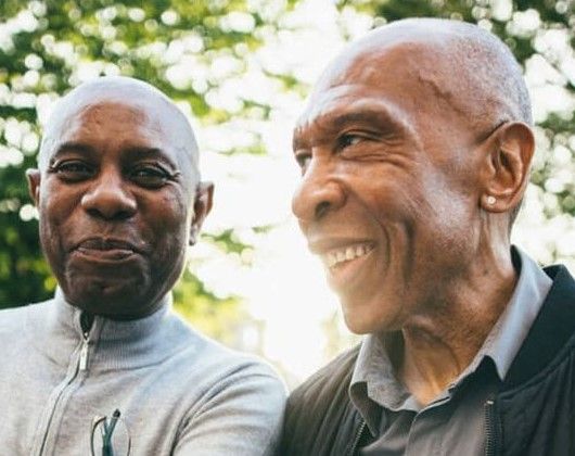 Two Black men smiling together