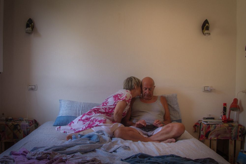 Man and woman sharing an intimate moment in bed