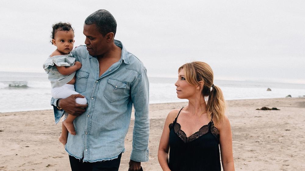 Family with baby walking on the beach