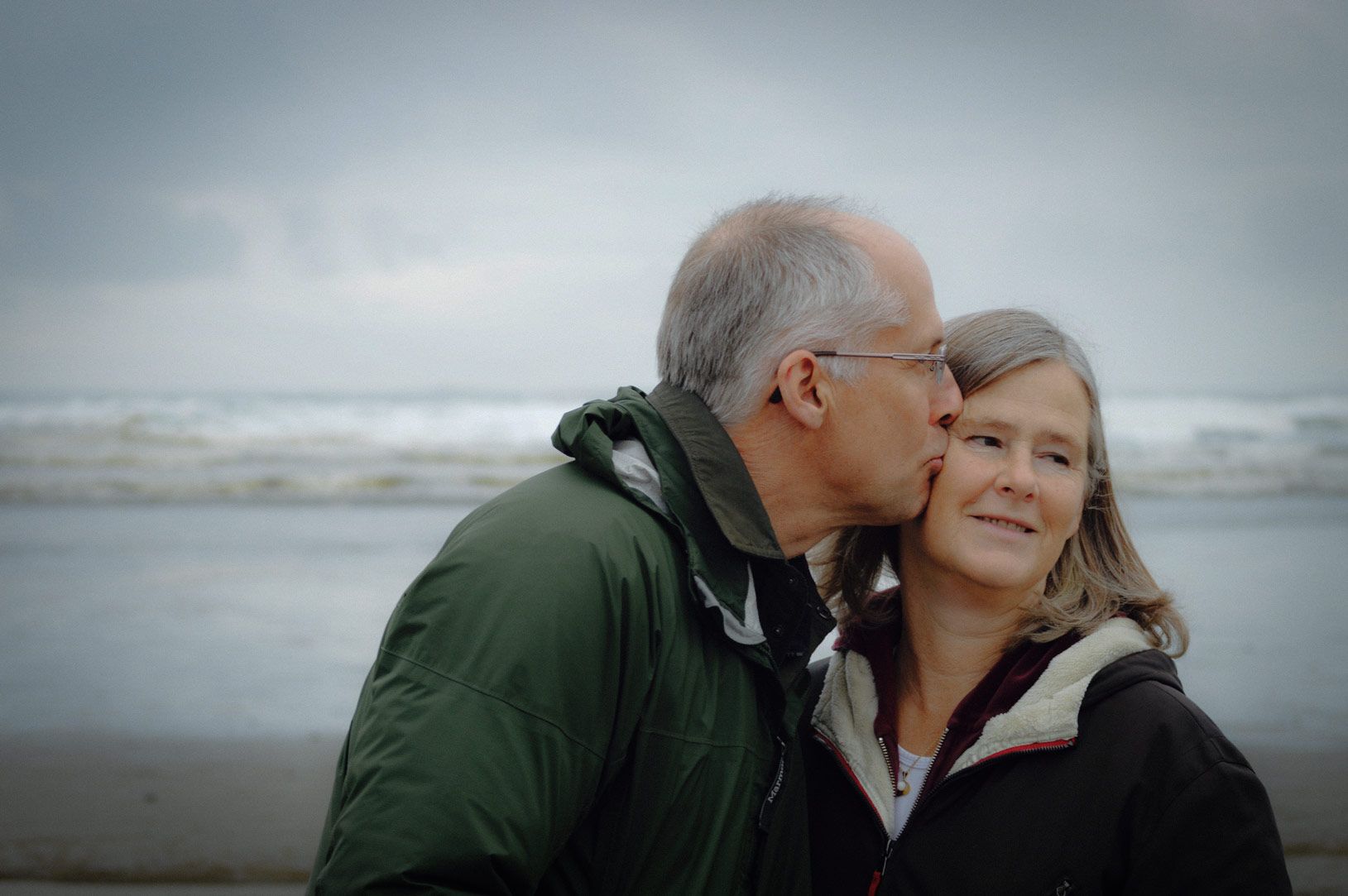 Close up of older man kissing his female partner on the cheek