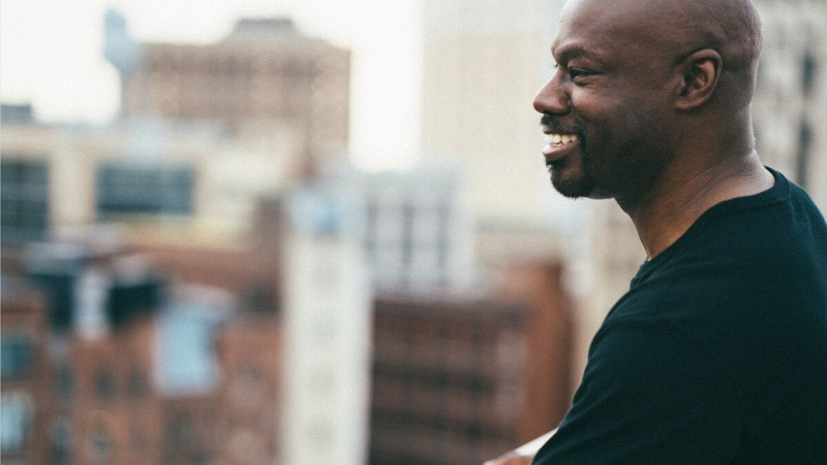 Close up of Black man looking out at city buildings