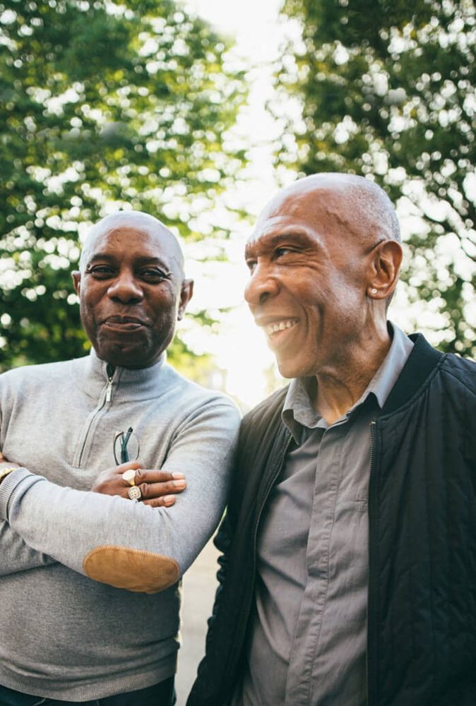 Close up of two Black men chatting outdoors