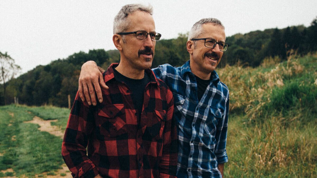 Close up of two men walking outdoors